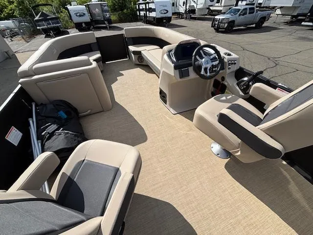Slide: The Image of Interior of 2025 Harris CRUISER 230 SLDH pontoon boat with beige seating and steering console. - 21