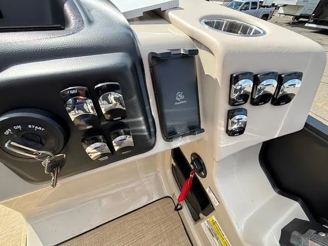 Slide: The Image of Control panel of 2025 Harris CRUISER 230 SLDH boat with switches and ignition key. - 23
