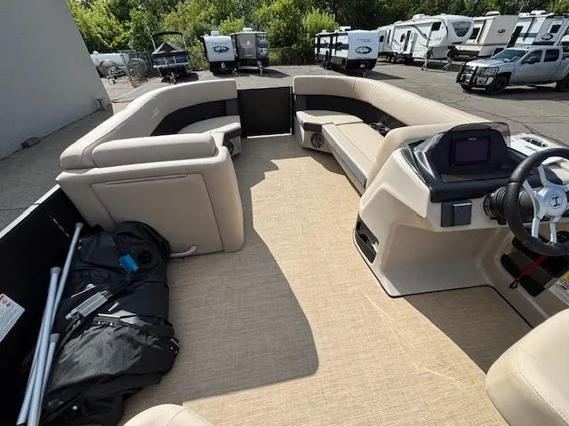 Slide: The Image of 2025 Harris CRUISER 230 SLDH pontoon boat interior with beige seating and modern dashboard. - 26