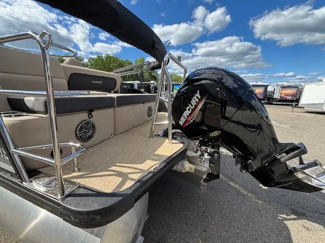 Slide: The Image of 2025 Harris CRUISER 230 SLDH pontoon boat with Mercury outboard motor, docked under blue skies. - 4