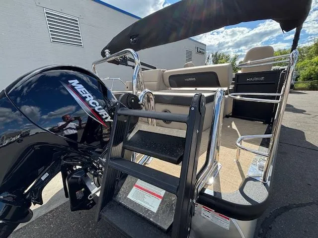 Slide: The Image of 2025 Harris CRUISER 230 SLDH boat with Mercury engine and ladder, outdoor setting. - 5