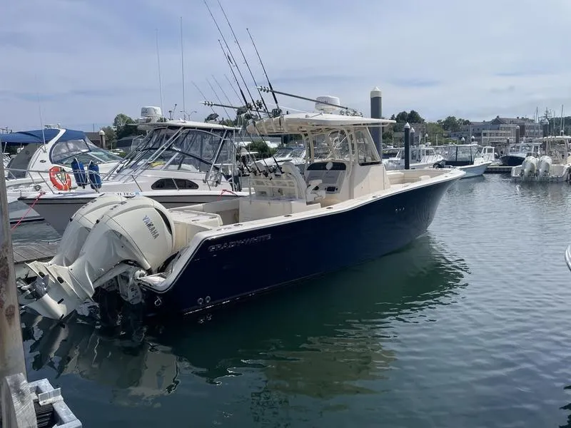 Slide: The Image of 2024 Grady-White 306 CANYON boat docked in marina, featuring Yamaha engines. - 0