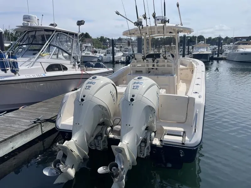 Slide: The Image of 2024 Grady-White 306 CANYON boat docked with twin outboard engines. - 1