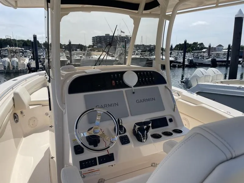 Slide: The Image of 2024 Grady-White 306 CANYON boat helm with Garmin displays at marina. - 3