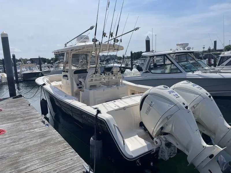 Slide: The Image of 2024 Grady-White 306 CANYON boat docked with twin outboard engines. - 4
