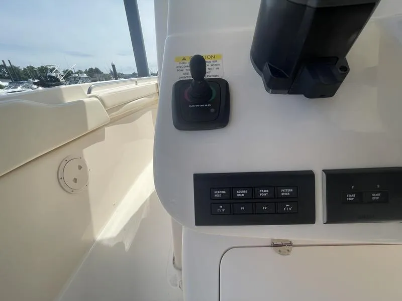 Slide: The Image of 2024 Grady-White 306 CANYON boat control panel with joystick and navigation buttons. - 5