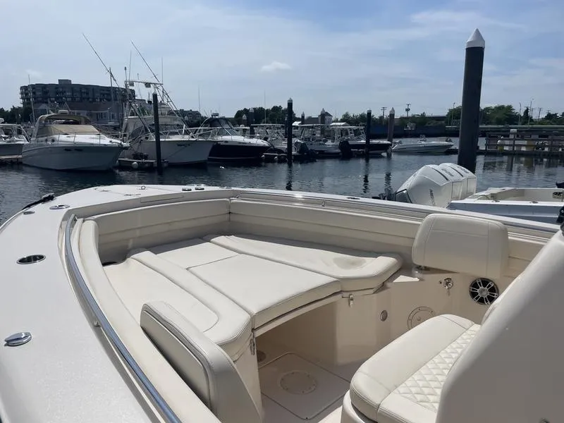 Slide: The Image of 2024 Grady-White 306 CANYON boat interior at marina, featuring comfortable seating. - 6