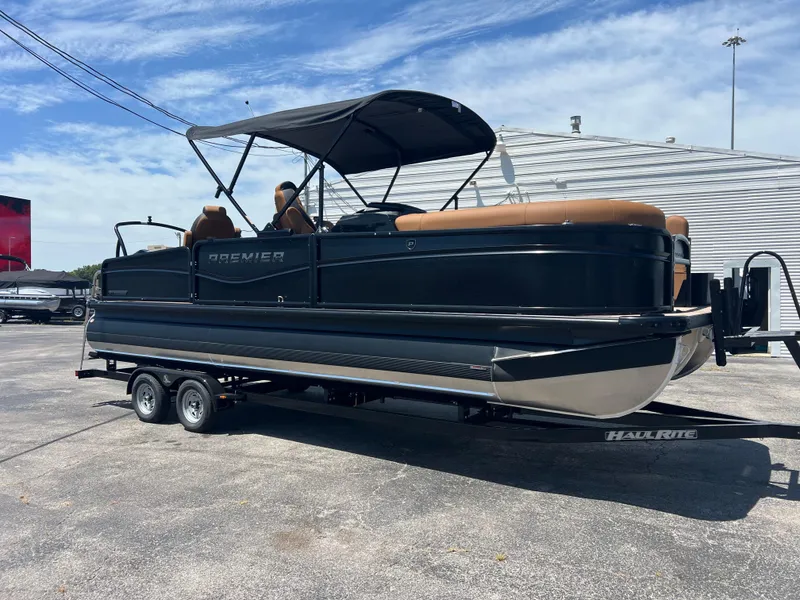 The Image of 2026 Premier 230 SunSation Angler pontoon boat on trailer, outdoor display. - 1