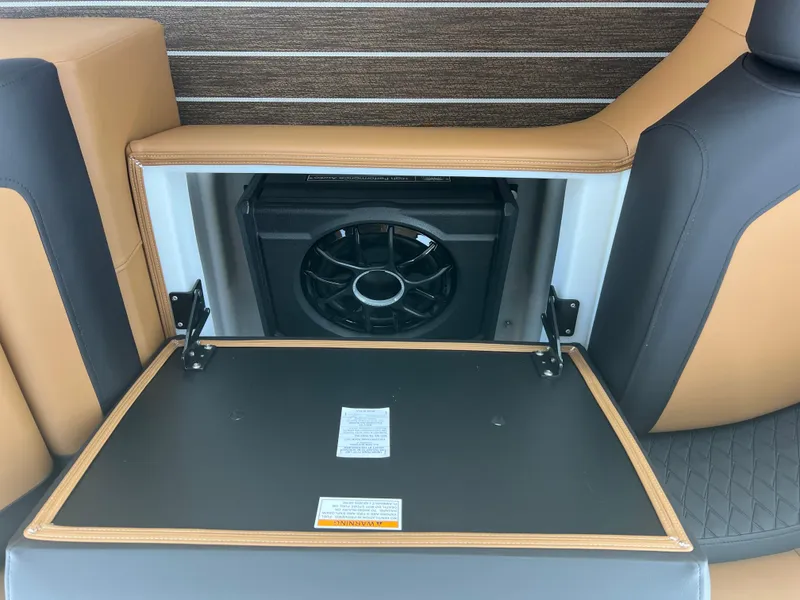 Slide: The Image of 2026 Premier 230 SunSation Angler boat interior with storage compartment and speaker. - 11