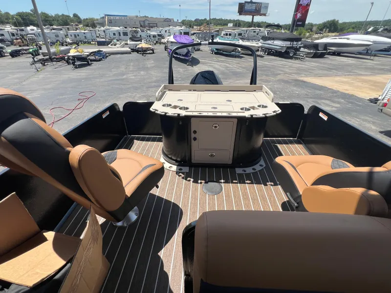 Slide: The Image of 2026 Premier 230 SunSation Angler boat interior with seating and console, displayed outdoors. - 7