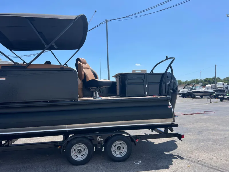 Slide: The Image of 2026 Premier 230 SunSation Angler pontoon boat on trailer, outdoor setting. - 8