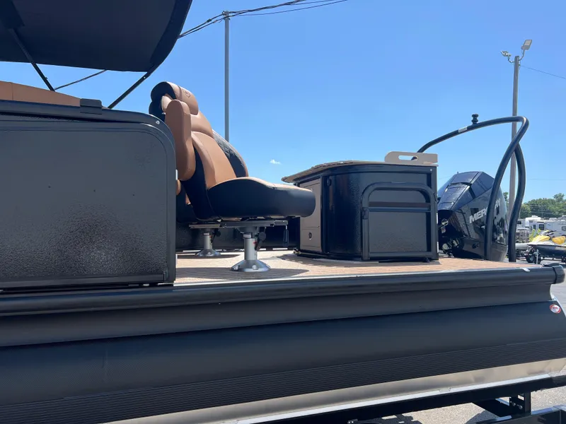 Slide: The Image of 2026 Premier 230 SunSation Angler pontoon boat interior with seating and motor. - 9