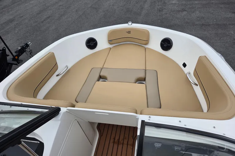 Slide: The Image of 2024 Bayliner VR5 Bowrider I/O boat interior with tan seating and wood flooring. - 15