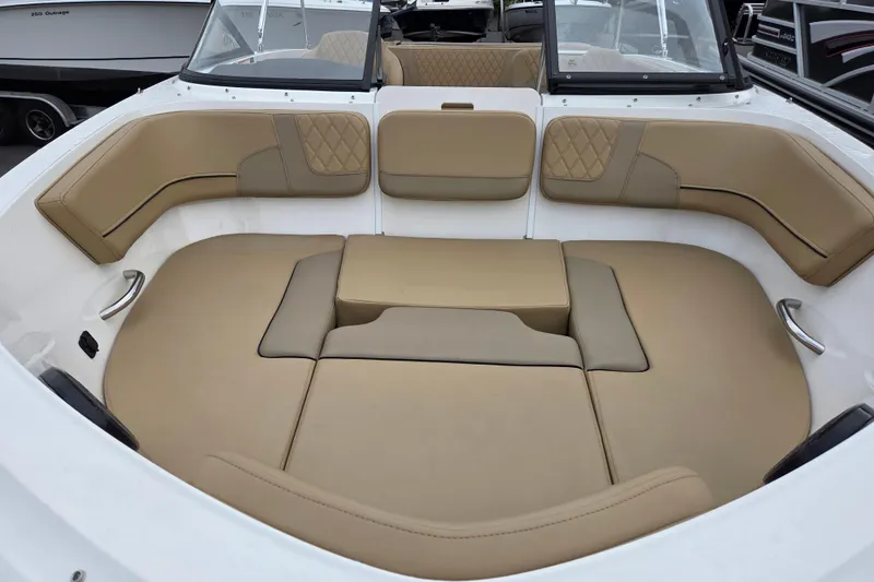 Slide: The Image of 2024 Bayliner VR5 Bowrider I/O interior with tan cushioned seating and sleek design. - 9