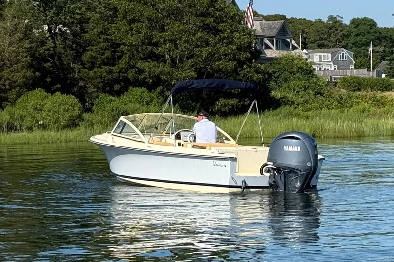 Slide: The Image of 2026 Rossiter R20 Day Boat cruising on a serene lake with lush greenery. - 11