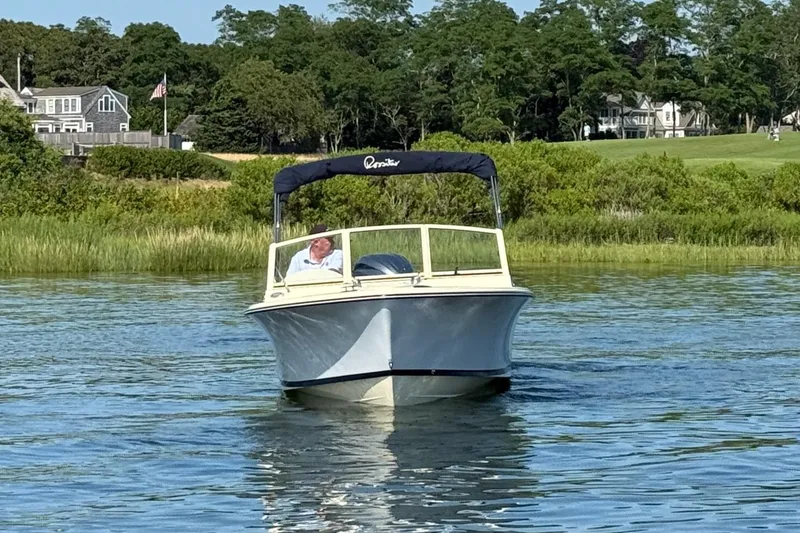 Slide: The Image of 2026 Rossiter R20 Day Boat cruising on a serene lake with lush greenery. - 4