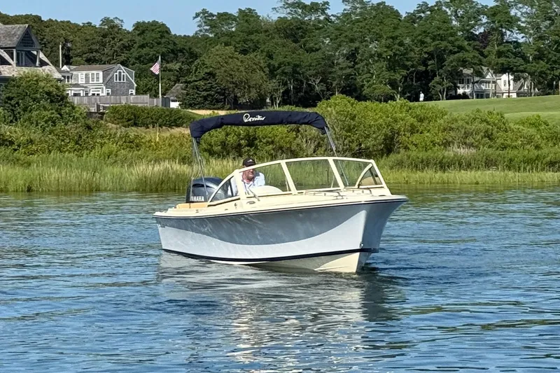 Slide: The Image of 2026 Rossiter R20 Day Boat cruising on a serene lake with lush greenery. - 5