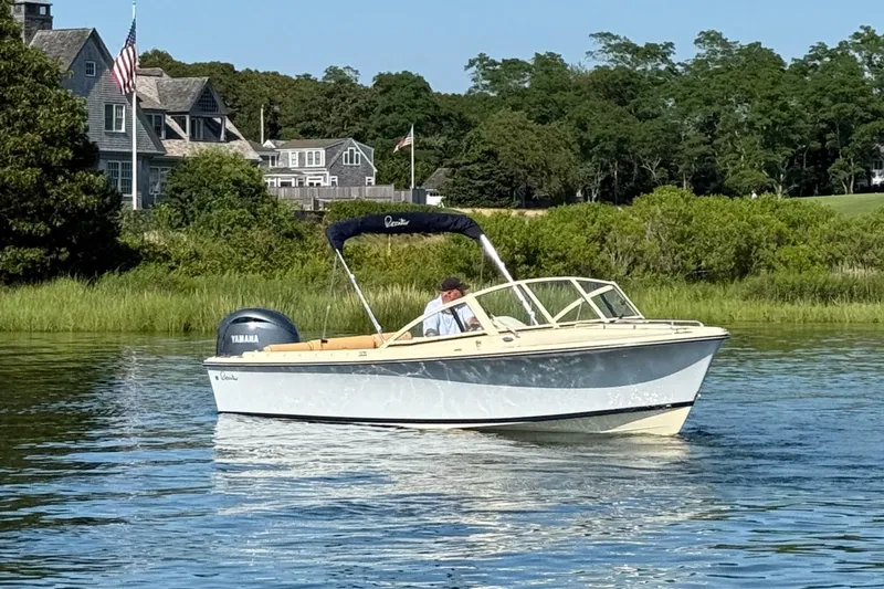 Slide: The Image of 2026 Rossiter R20 Day Boat cruising on a serene lake near a picturesque house. - 6