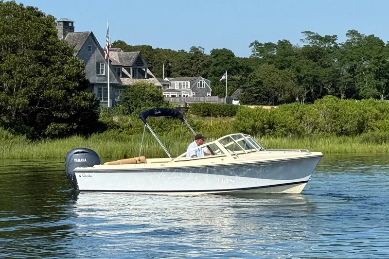 Slide: The Image of 2026 Rossiter R20 Day Boat cruising on a serene lake near a charming lakeside house. - 7