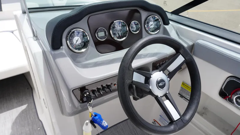Slide: The Image of 2022 Chaparral 23 SSi boat dashboard with steering wheel and gauges. - 16