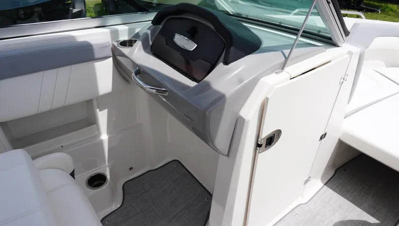 Slide: The Image of 2022 Chaparral 23 SSi boat interior with sleek dashboard and seating area. - 17