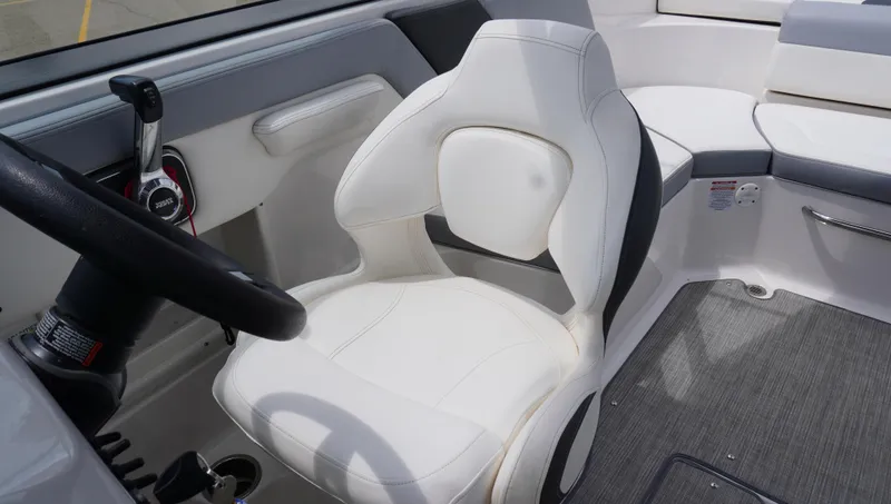 Slide: The Image of 2022 Chaparral 23 SSi boat interior with white captain's seat and steering wheel. - 18