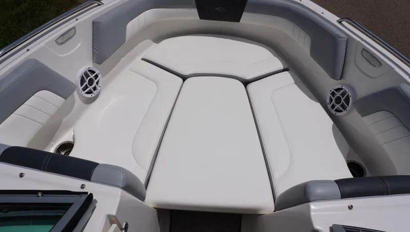 Slide: The Image of 2022 Chaparral 23 SSi boat interior with white cushioned seating and speakers. - 20