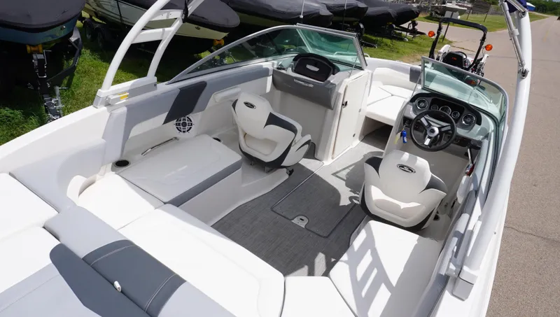 Slide: The Image of 2022 Chaparral 23 SSi boat interior with modern seating and dashboard. - 21