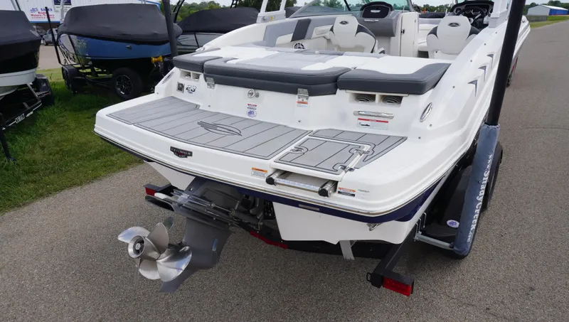 Slide: The Image of 2022 Chaparral 23 SSi boat with sleek design and powerful outboard motor. - 4