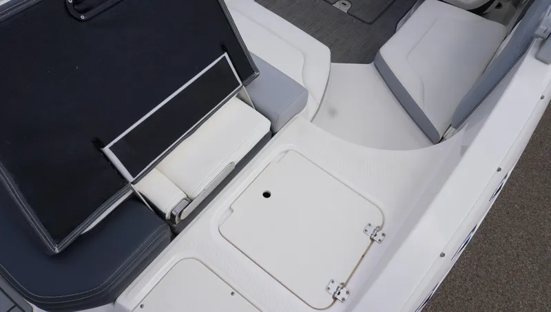 Slide: The Image of 2022 Chaparral 23 SSi boat interior with storage compartment and seating area. - 8
