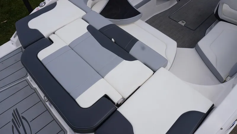Slide: The Image of 2022 Chaparral 23 SSi boat interior with gray and white cushioned seating. - 9