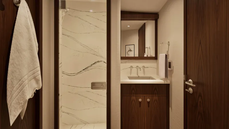 Slide: The Image of Luxurious bathroom interior of 2026 Hatteras 77 Convertible yacht, featuring elegant wood and marble finishes. - 15