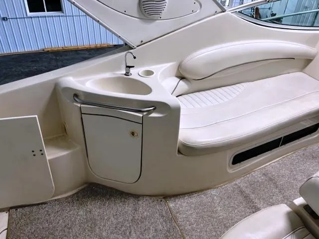 Slide: The Image of 2001 Maxum 2700 SCR boat interior with seating and sink area. - 10