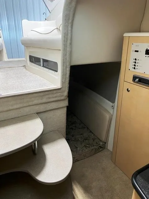 Slide: The Image of Interior of 2001 Maxum 2700 SCR boat, featuring steps and cabin area. - 12