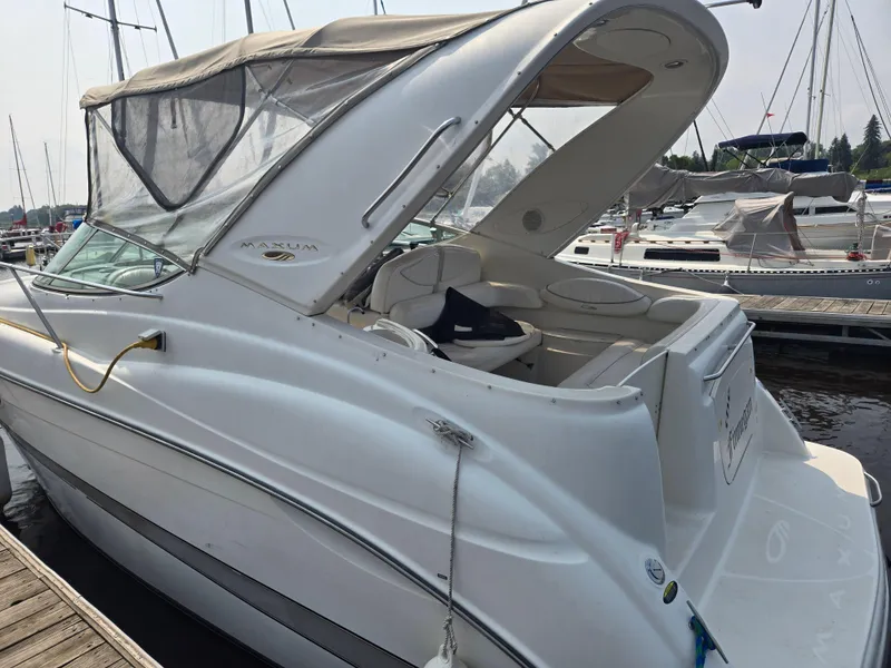 Slide: The Image of 2001 Maxum 2700 SCR boat docked at marina, featuring sleek design and spacious interior. - 2