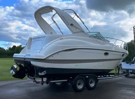 Slide: The Image of 2001 Maxum 2700 SCR boat on trailer, parked outdoors under cloudy sky. - 3