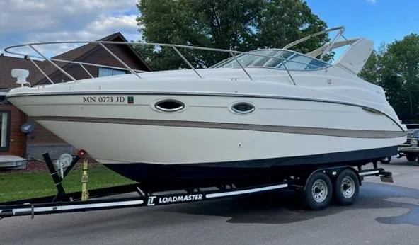 Slide: The Image of 2001 Maxum 2700 SCR boat on Loadmaster trailer, parked outdoors. - 4