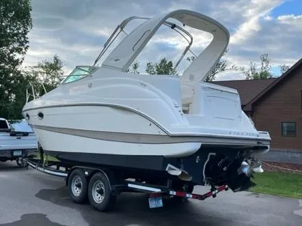 Slide: The Image of 2001 Maxum 2700 SCR boat on trailer, parked outdoors under cloudy sky. - 5
