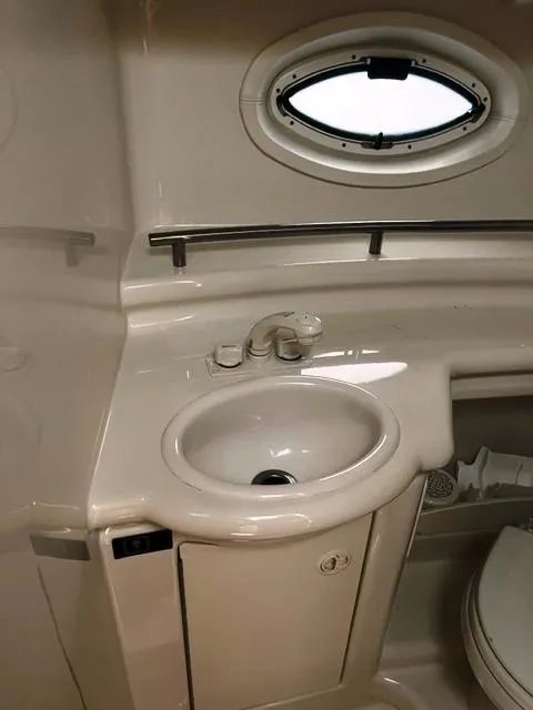 Slide: The Image of 2001 Maxum 2700 SCR boat bathroom with sink, porthole, and toilet. - 6