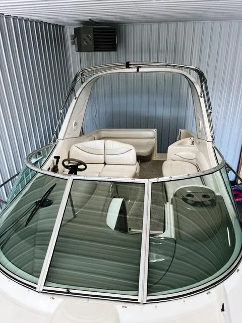 Slide: The Image of 2001 Maxum 2700 SCR boat in storage, featuring sleek design and comfortable seating. - 7