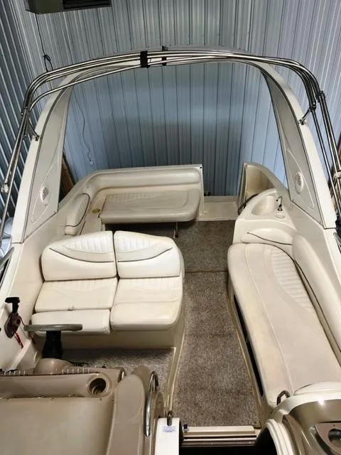 Slide: The Image of 2001 Maxum 2700 SCR boat interior with white seating and carpeted floor. - 8