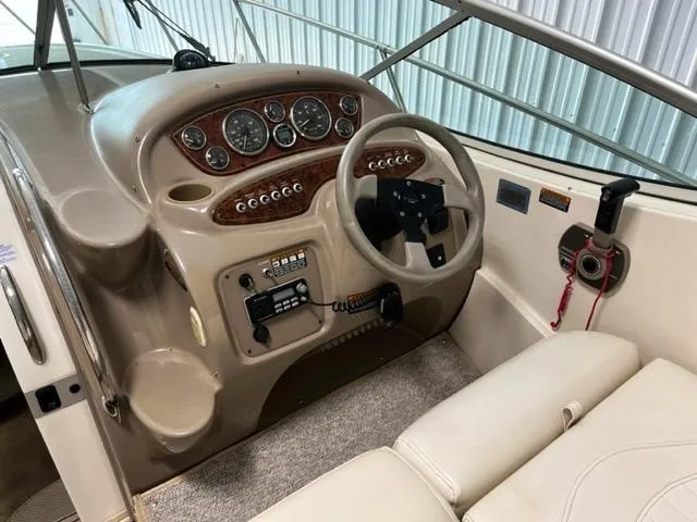 Slide: The Image of 2001 Maxum 2700 SCR boat dashboard with steering wheel and control panel. - 9