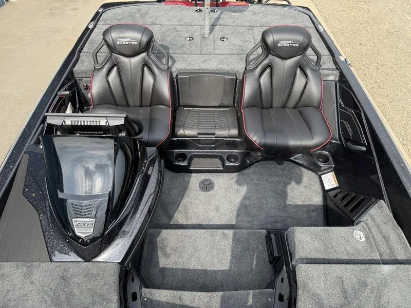 Slide: The Image of 2025 Skeeter ZXR20 boat interior with dual black seats and carpeted flooring. - 11