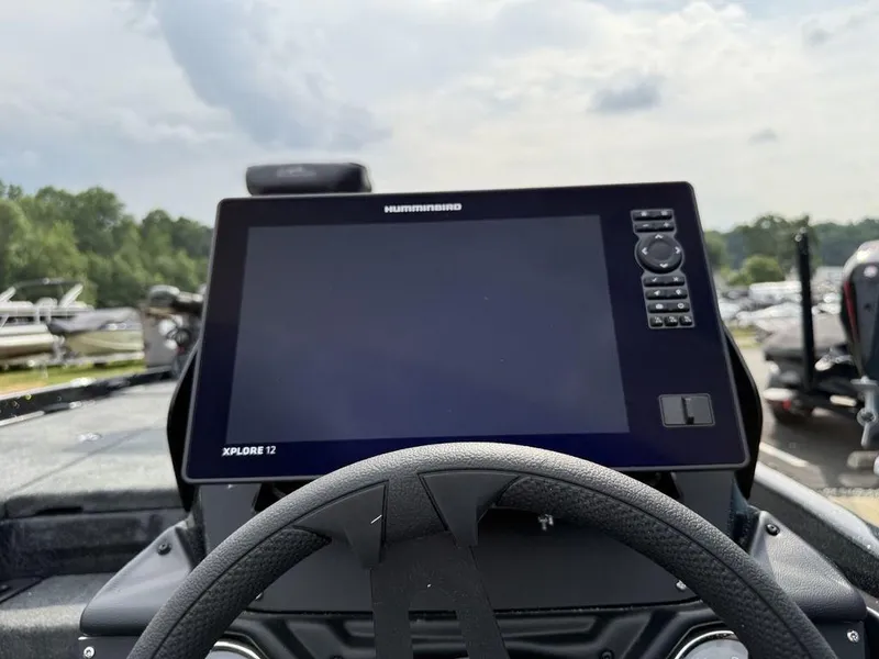 Slide: The Image of 2025 Skeeter ZXR20 boat dashboard with Humminbird Xplore 12 display and steering wheel. - 12