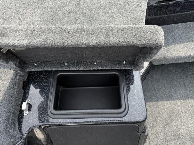 Slide: The Image of Open storage compartment in 2025 Skeeter ZXR20 boat, featuring carpeted interior. - 14