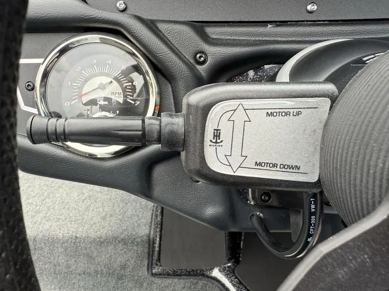 Slide: The Image of 2025 Skeeter ZXR20 boat control panel with RPM gauge and motor adjustment switch. - 17