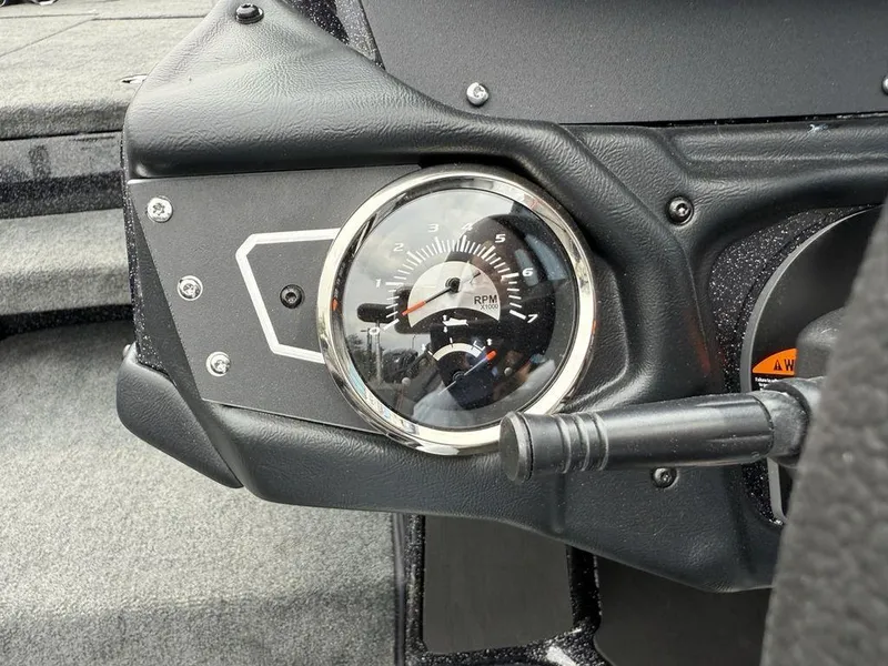 Slide: The Image of Tachometer on 2025 Skeeter ZXR20 boat dashboard, showing RPM gauge and control lever. - 20