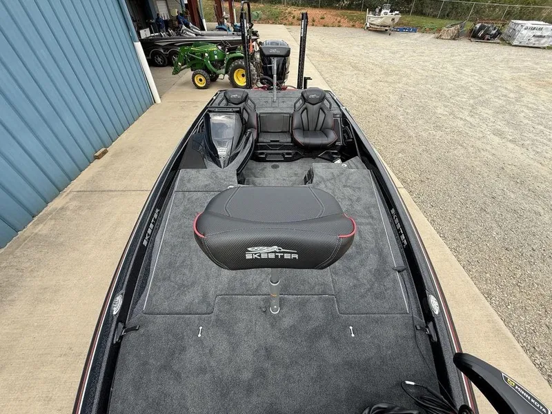 Slide: The Image of 2025 Skeeter ZXR20 boat with sleek design, parked near a blue building. - 24