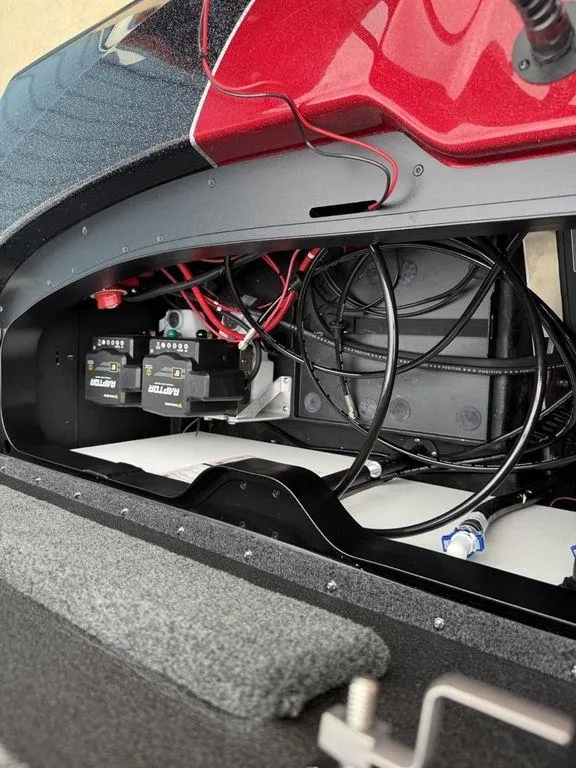 Slide: The Image of 2025 Skeeter ZXR20 boat battery compartment with wiring and components. - 27