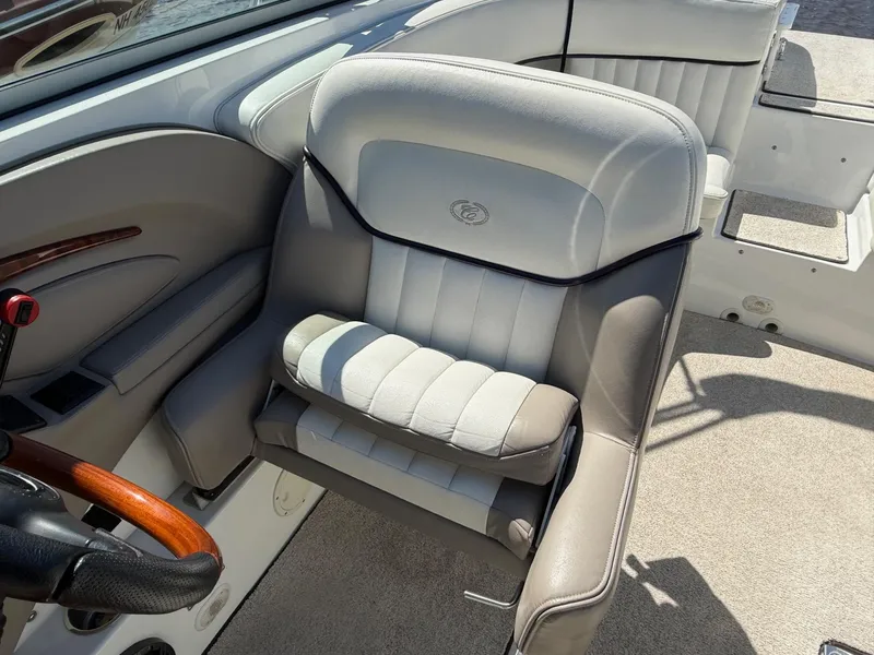 Slide: The Image of Captain's seat on a 2002 Cobalt 262 boat, featuring leather upholstery and wood accents. - 10